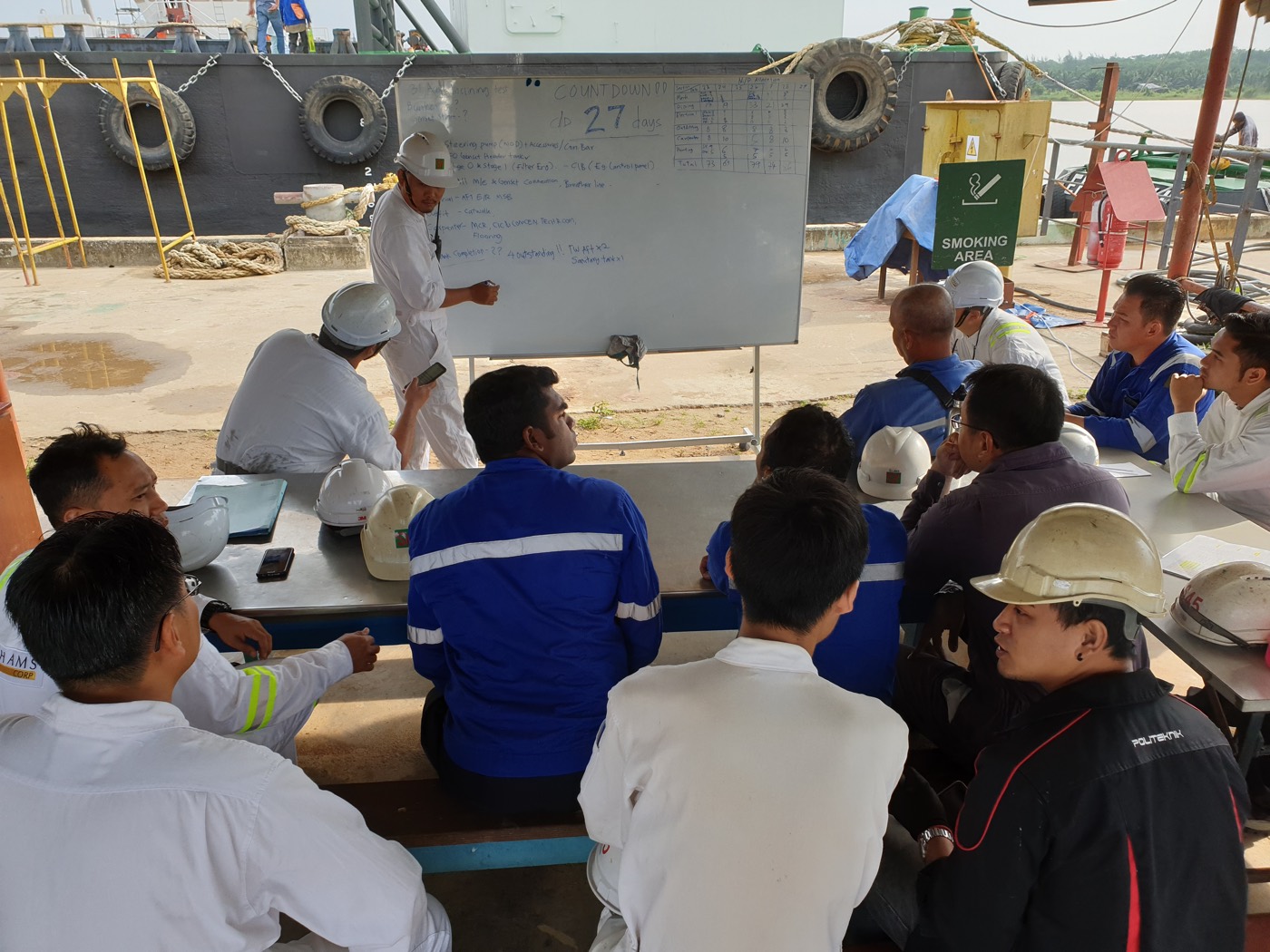 Engineers and foremen meeting at the quayside